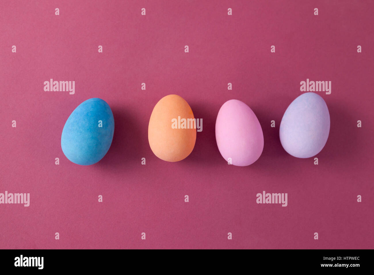 Colorful Easter eggs arranged on pink background Stock Photo - Alamy