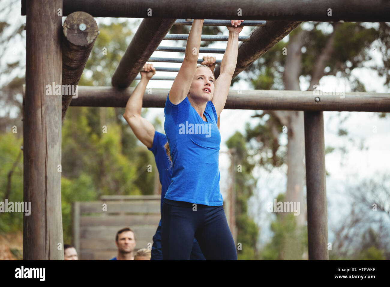 Fit people climbing monkey bars in bootcamp Stock Photo Alamy