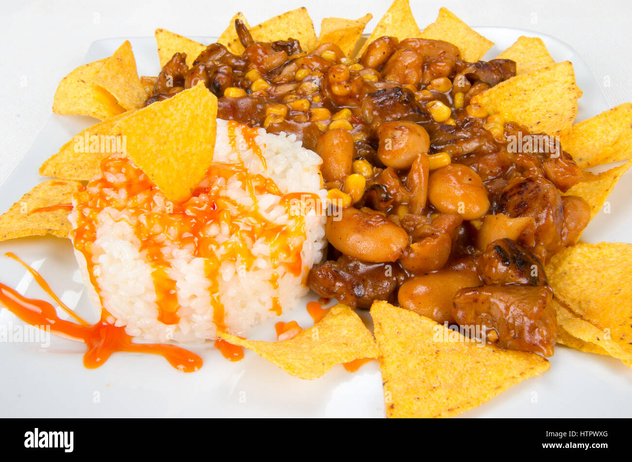 Dish of chips, beans, corn and white rice Stock Photo Alamy
