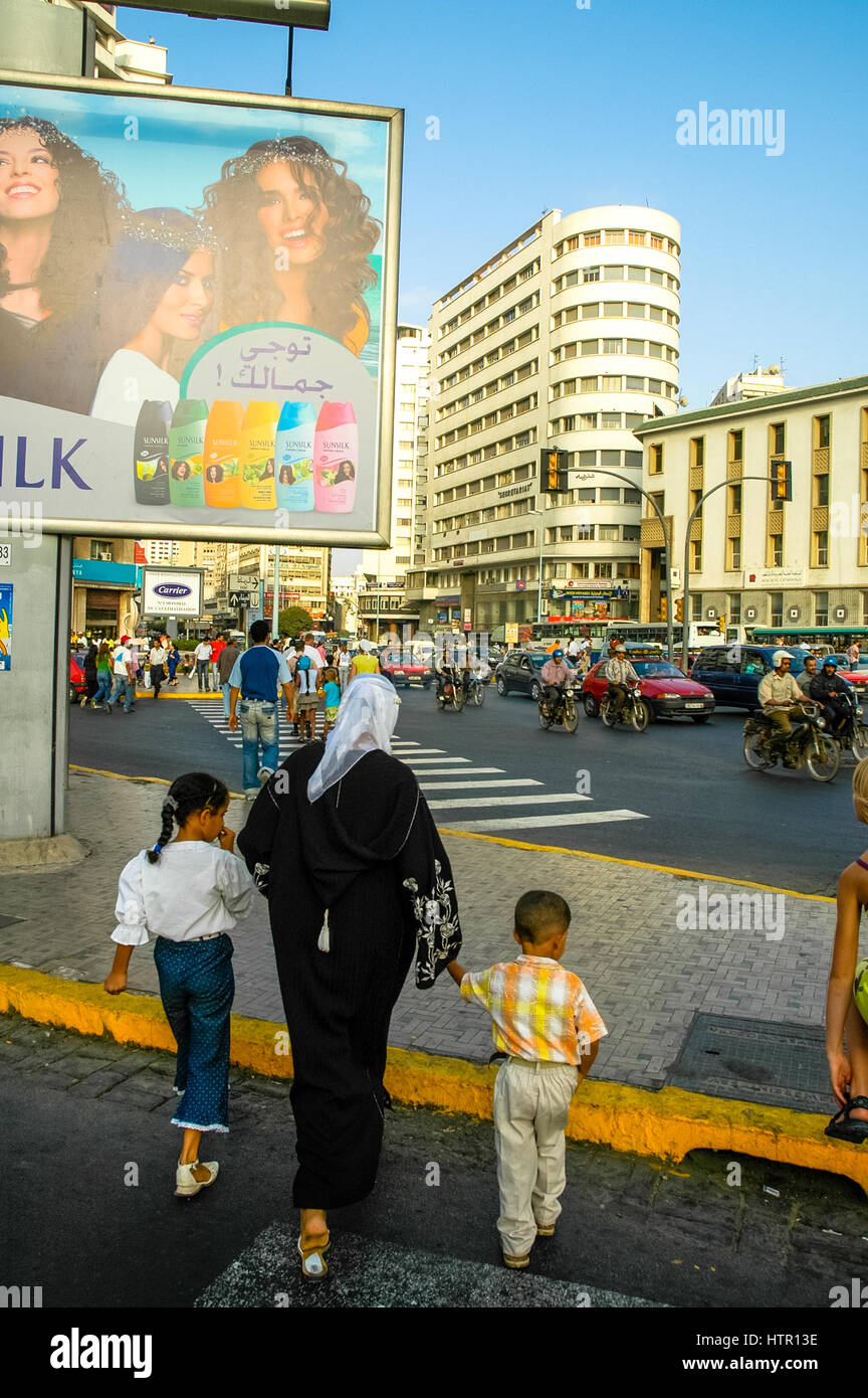 Mother and two children walking on street in Casablanca, Maroc Stock Photo