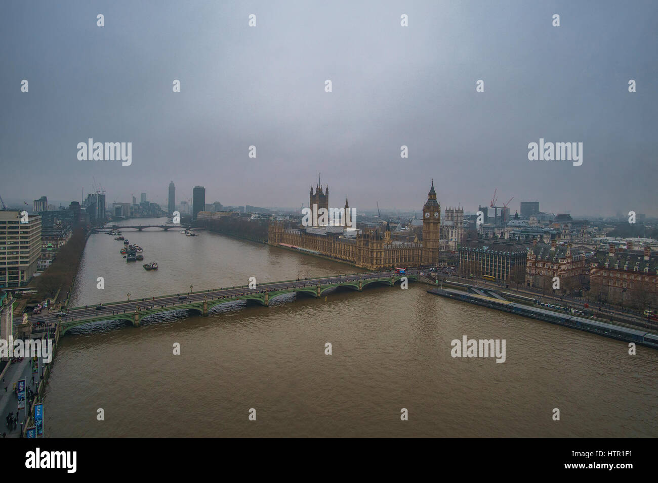 Panoramic Aerial view of Thames river in London against a cloudy sky in a foggy weather. London, United Kingdom. Stock Photo