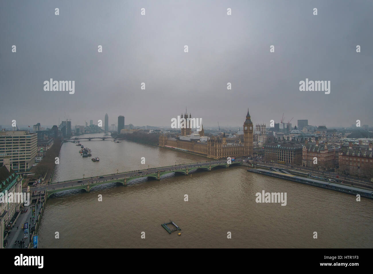 Panoramic Aerial view of Thames river in London against a cloudy sky in a foggy weather. London, United Kingdom. Stock Photo