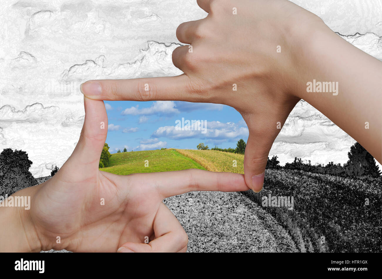 hands creating a square turning a drawing of a clean landscape into
