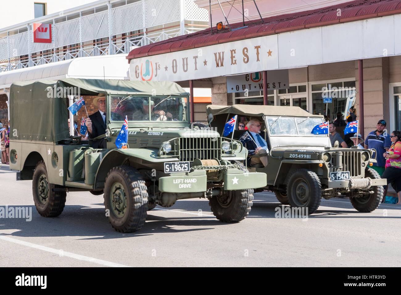 Charters Towers - April 25, 2016: Proud ex-servicemen ride in old army vehicles in Anzac Day parade in Charters Towers, Queensland, Australia Stock Photo