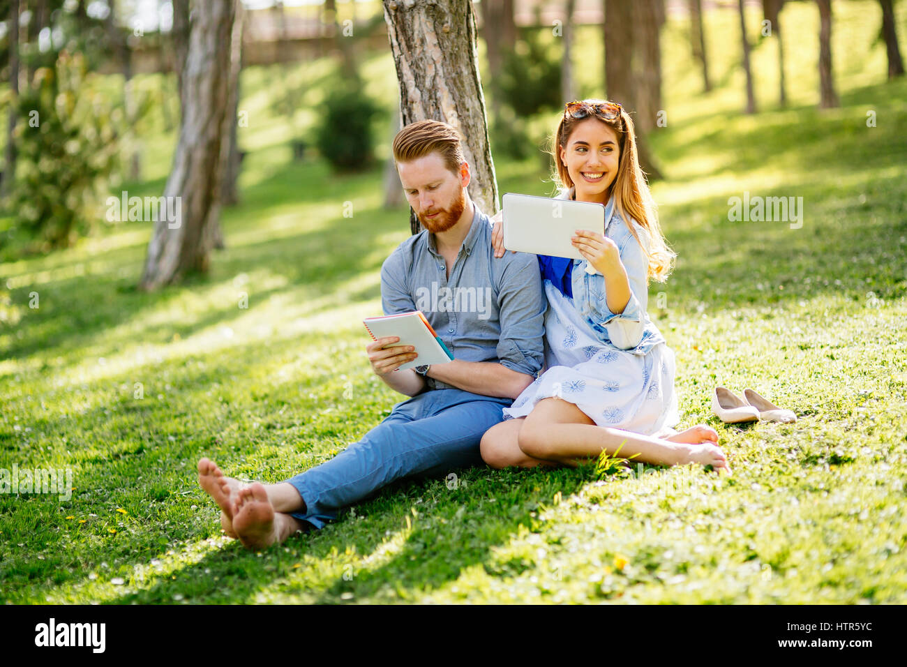 Lovely university students studying outdoors in park Stock Photo - Alamy