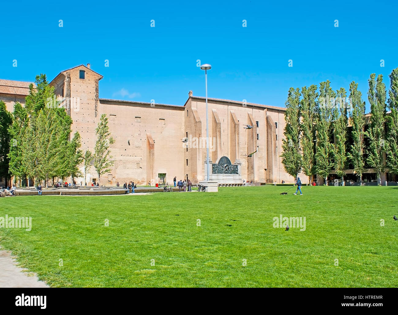 PARMA, ITALY - APRIL 24, 2012: The green lawn on Pace Square in front of the Palace of Pilotta, the medieval complex and one of the main place of tour Stock Photo