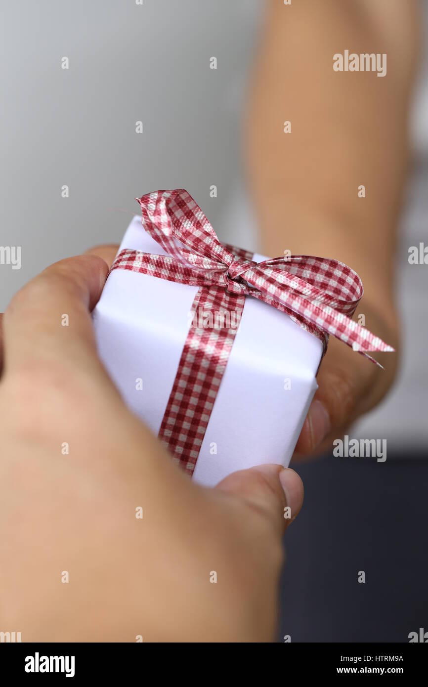 Hand of man giving a gift box,concept of Christmas and special occasions. Stock Photo
