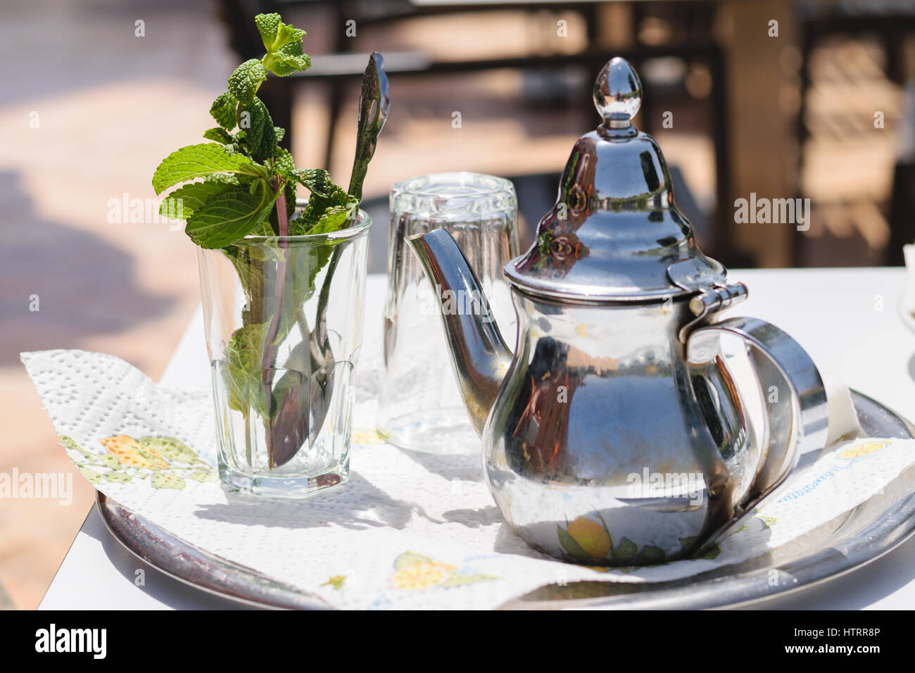 Image of a teapot and a glass with mint leaves to prepare a mint tea Moroccan style. Stock Photo