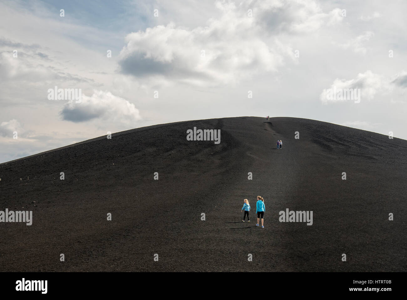 Visitors hiking on Inferno Cone at Craters of the Moon National Monument and Preserve, Idaho, USA. Stock Photo