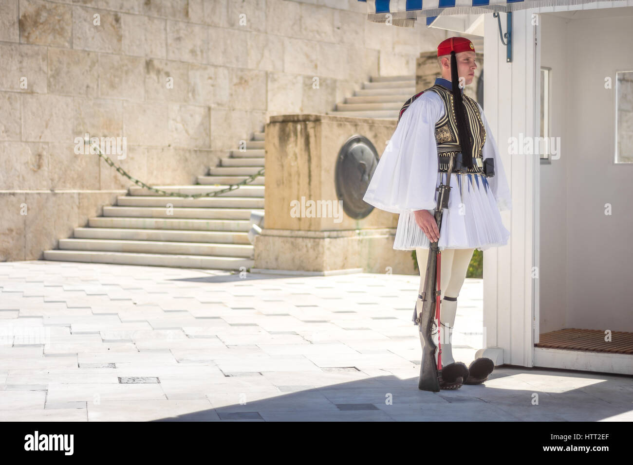 Athens, Greece - March 5, 2017: Evzonas dressed in traditional Greek army uniform (Tsolias) standing guard at the Unknown Soldier Tomp monument Stock Photo