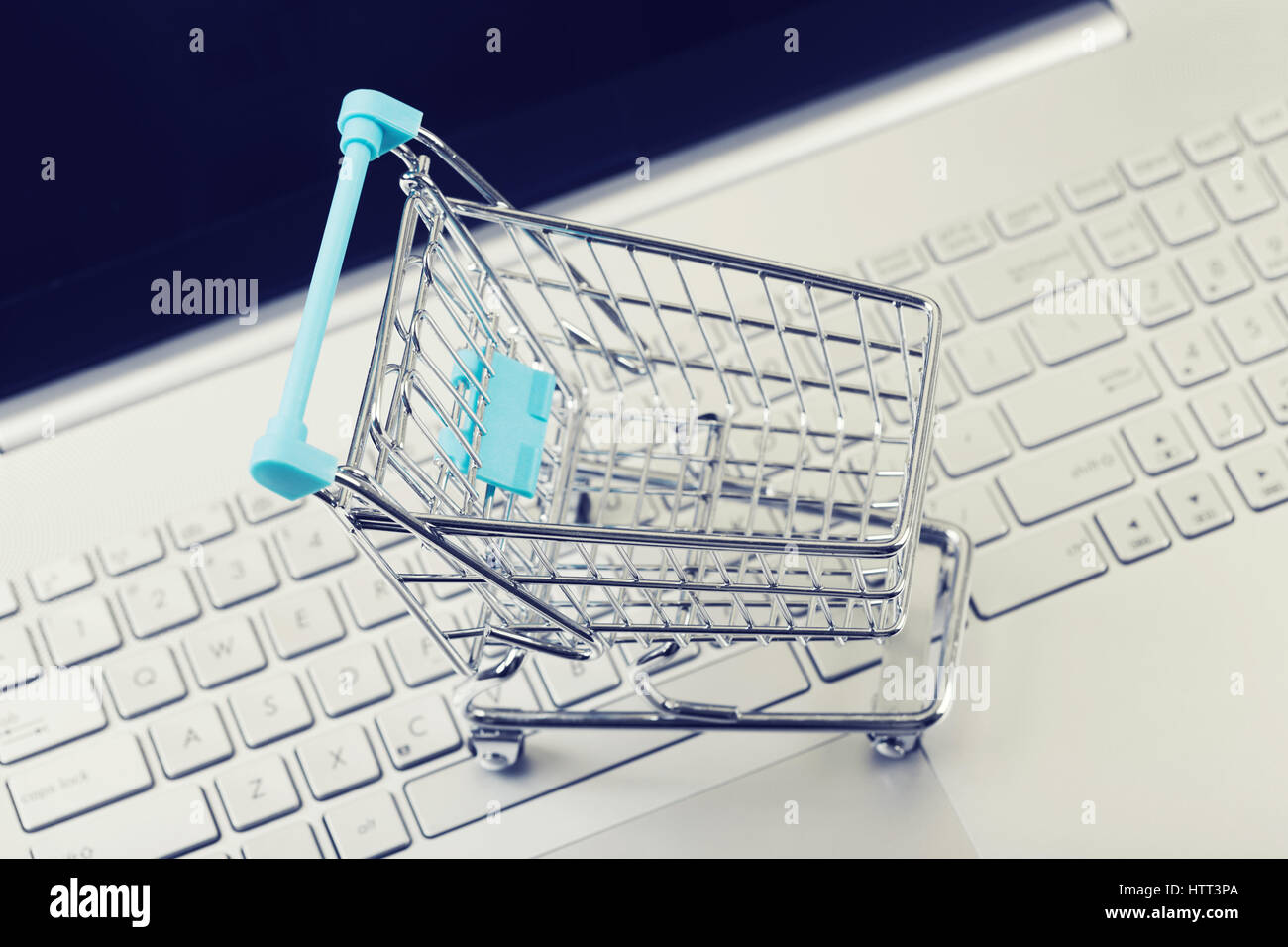 internet shopping concept - cart on computer keyboard Stock Photo