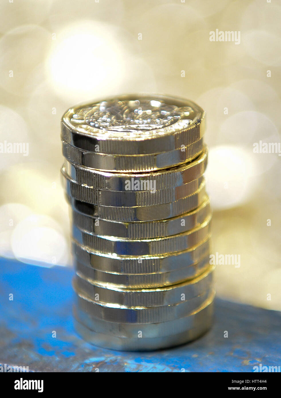 Editorial Use only &ETH; NO COMMERCIAL USE New 12-sided one pound coins stacked on the edge of a metal crate as they are minted at the Royal Mint in Llantrisant, Wales. Stock Photo