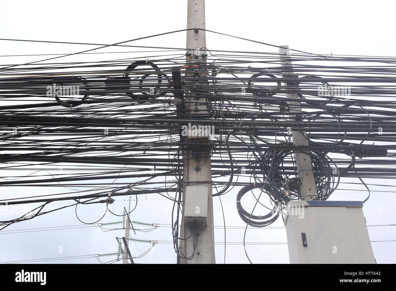 Messy cable electricity post due to poor planning on installing the cable system. Stock Photo