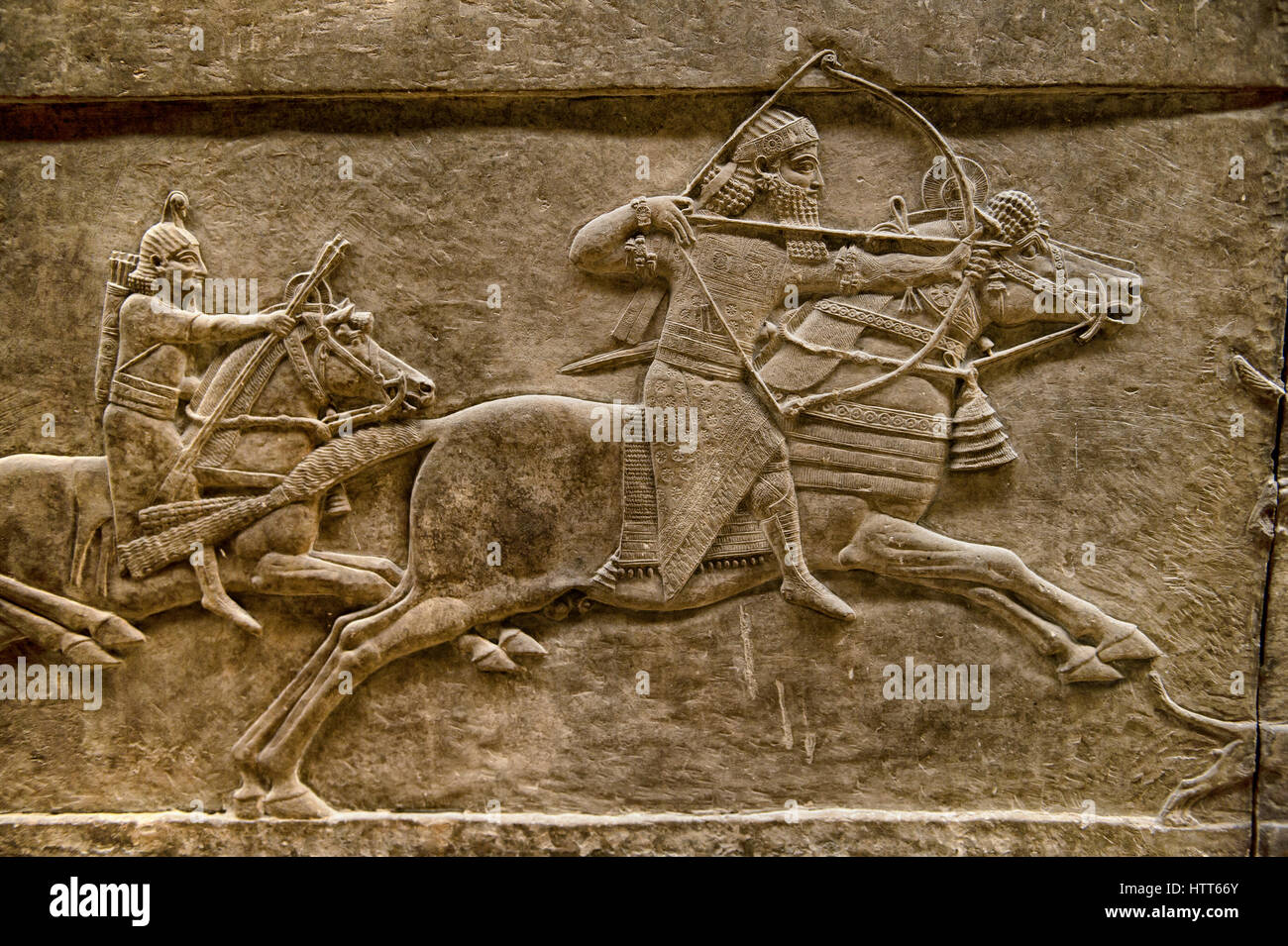 Assyrian relief sculpture panel of Ashurnasirpal lion hunting.  From Nineveh  North Palace, Iraq,  668-627 B.C.  British Museum Assyrian  Archaeologic Stock Photo