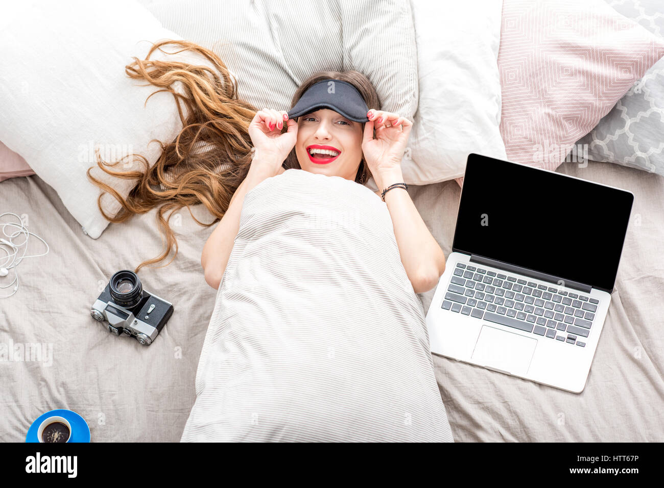 Woman on the bed with laptop Stock Photo - Alamy