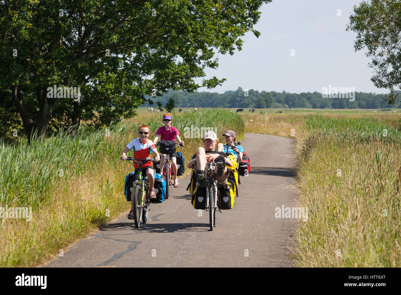 Family on holiday bicycle trip with recumbents and bicycles in the Netherlands Stock Photo