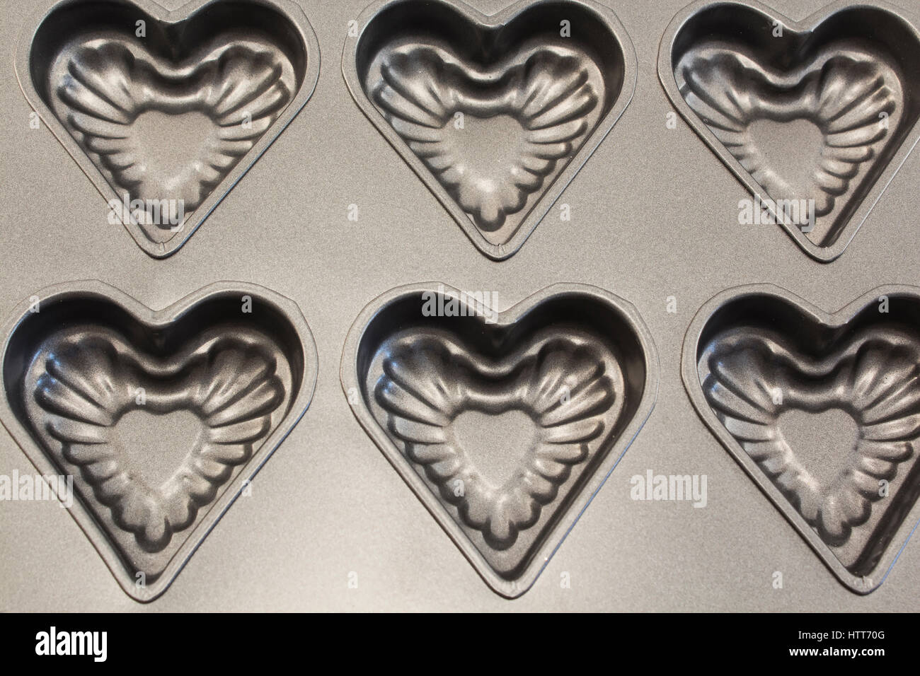 Baking Tray of Cookies in the Shape of Heart as a Background. Stock Photo