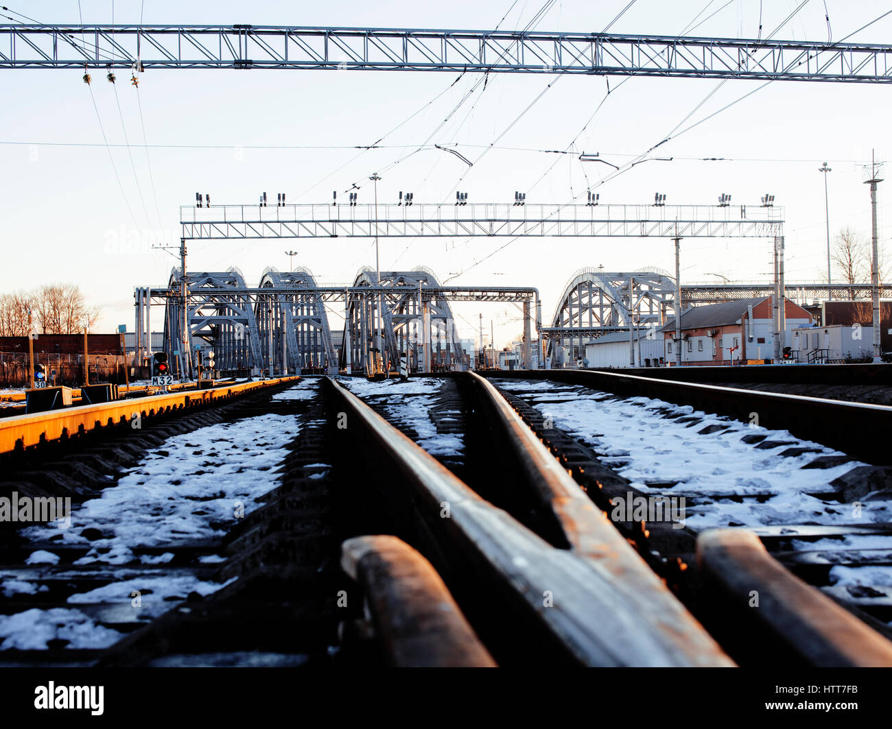landscape with railway with trains, lot of steel rafters at sunset ...