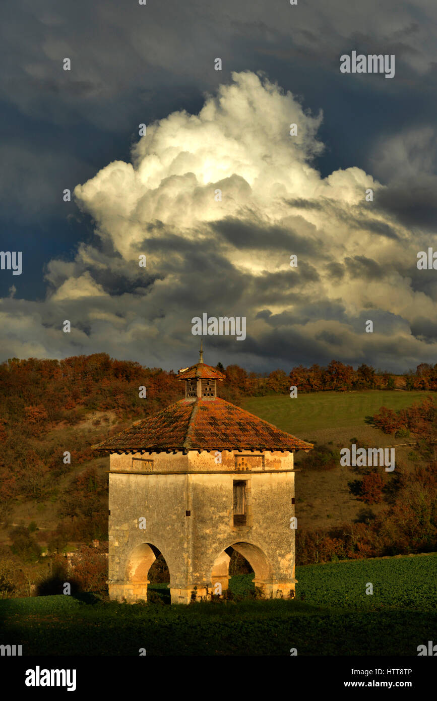 Storm clouds over a Pigeonnier at Cazelles, near Cordes-sur-Ciel, in the Occitanie region of southern France Stock Photo