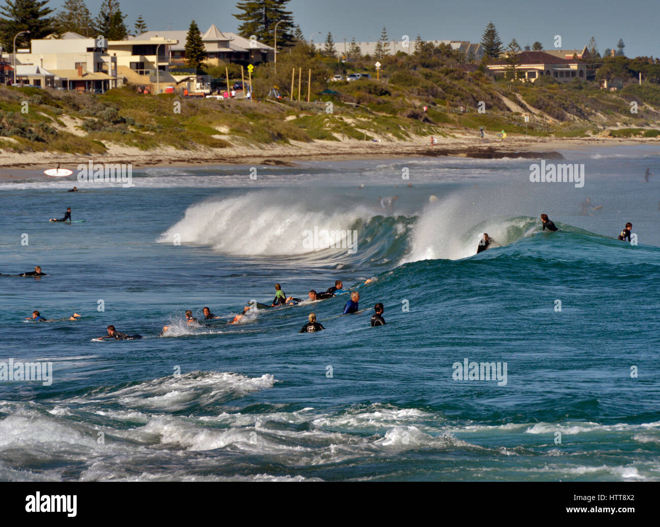 Surfers in the waves at Cottesloe Beach in Western Australia Stock Photo