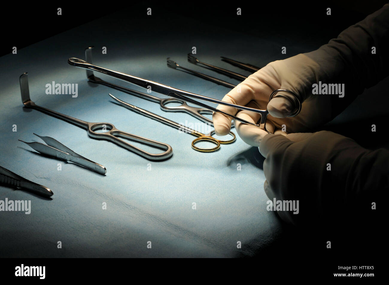 Surgical instruments in a hospital, with gloved hands prior to an
