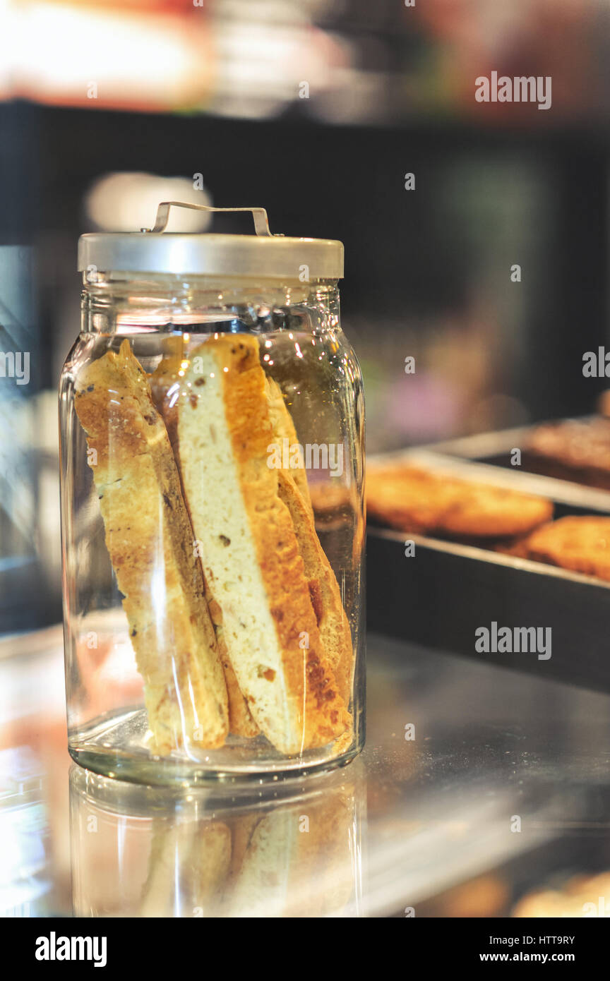 cookies in the jar over the coffee shop menu board Stock Photo