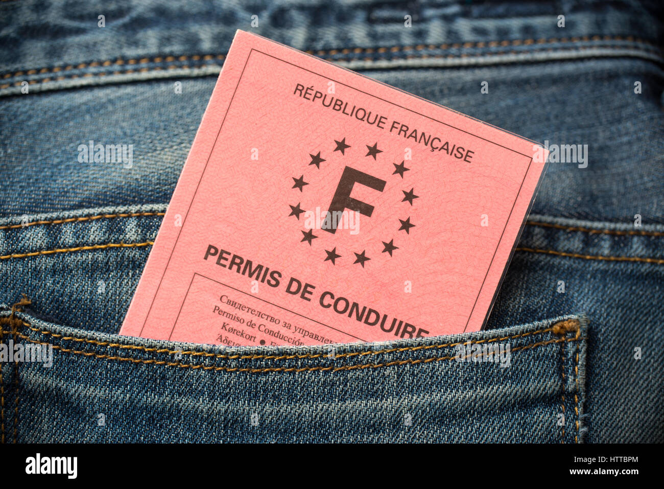 French driving license in the rear pocket of blue jeans, driving licence test concept Stock Photo