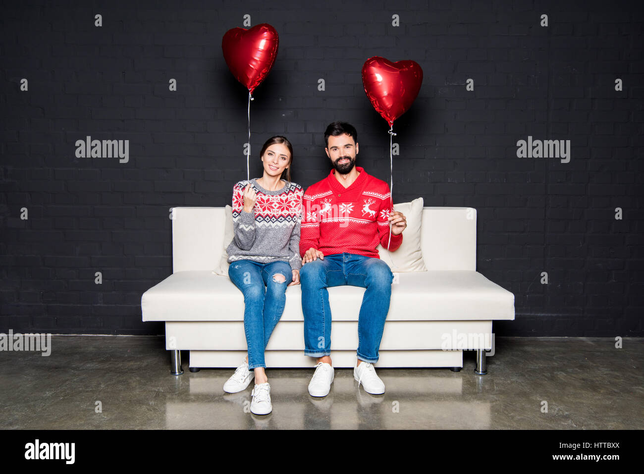 Couple with red hearts balloons Stock Photo - Alamy