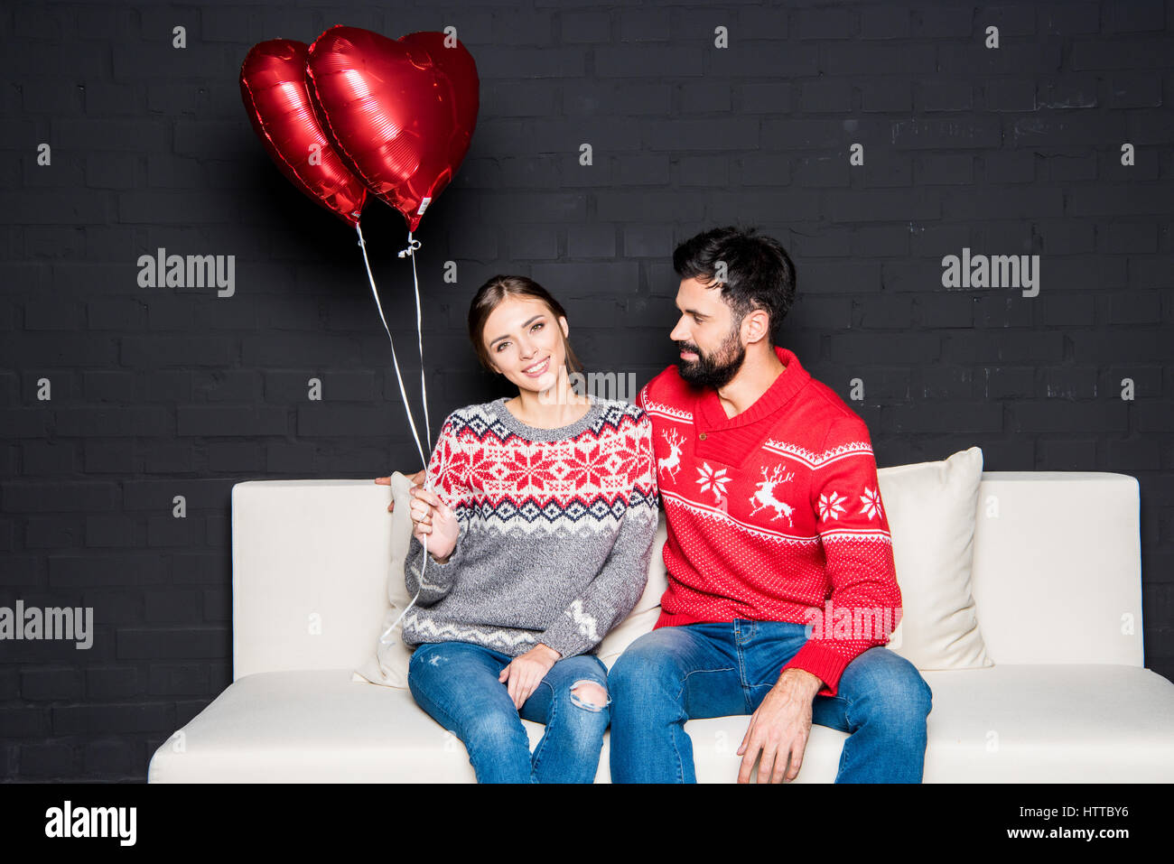 Couple with red hearts balloons Stock Photo - Alamy