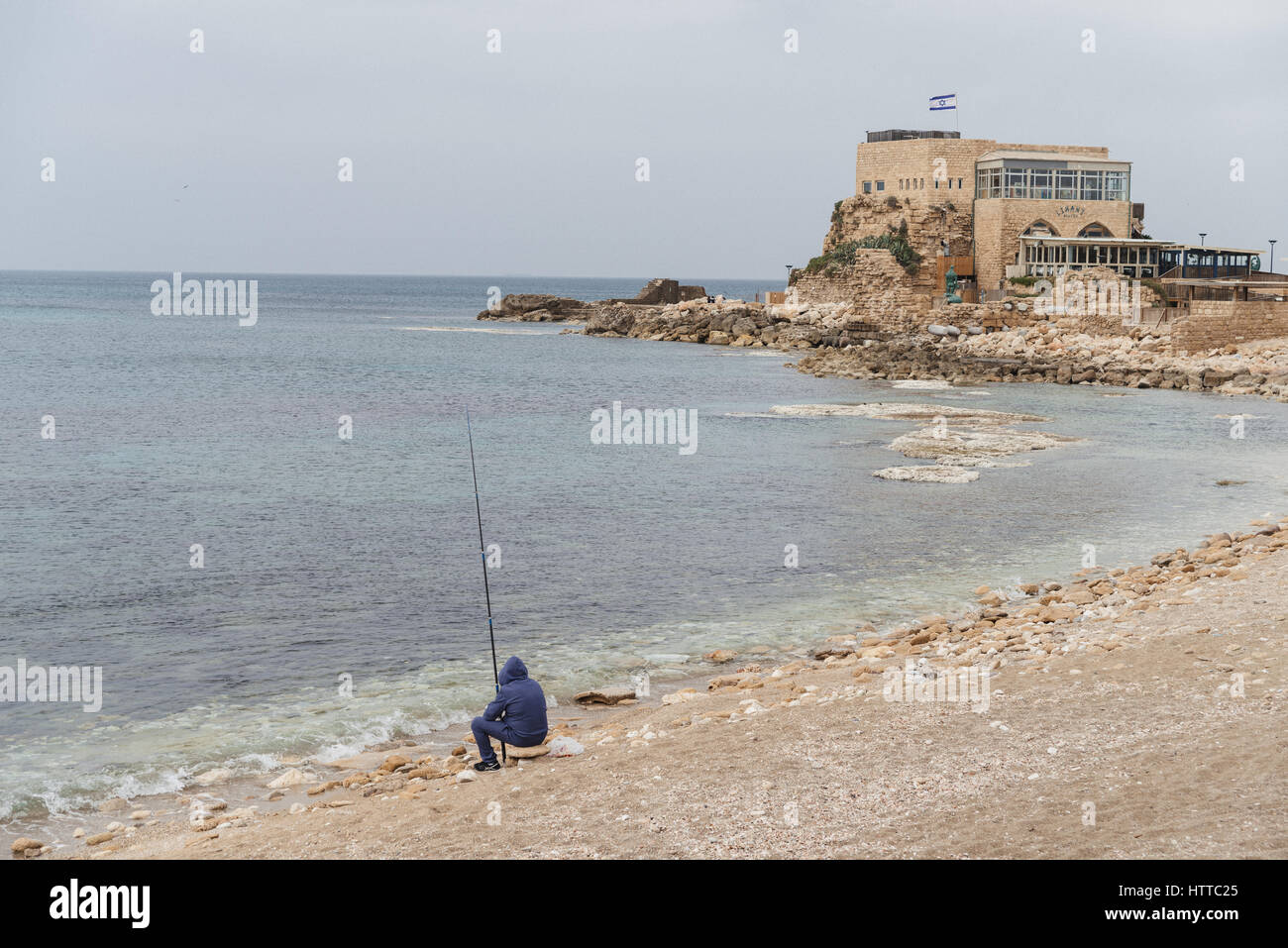 A fisherman on a territory of Maritima National Park in Caesarea, Israel Stock Photo