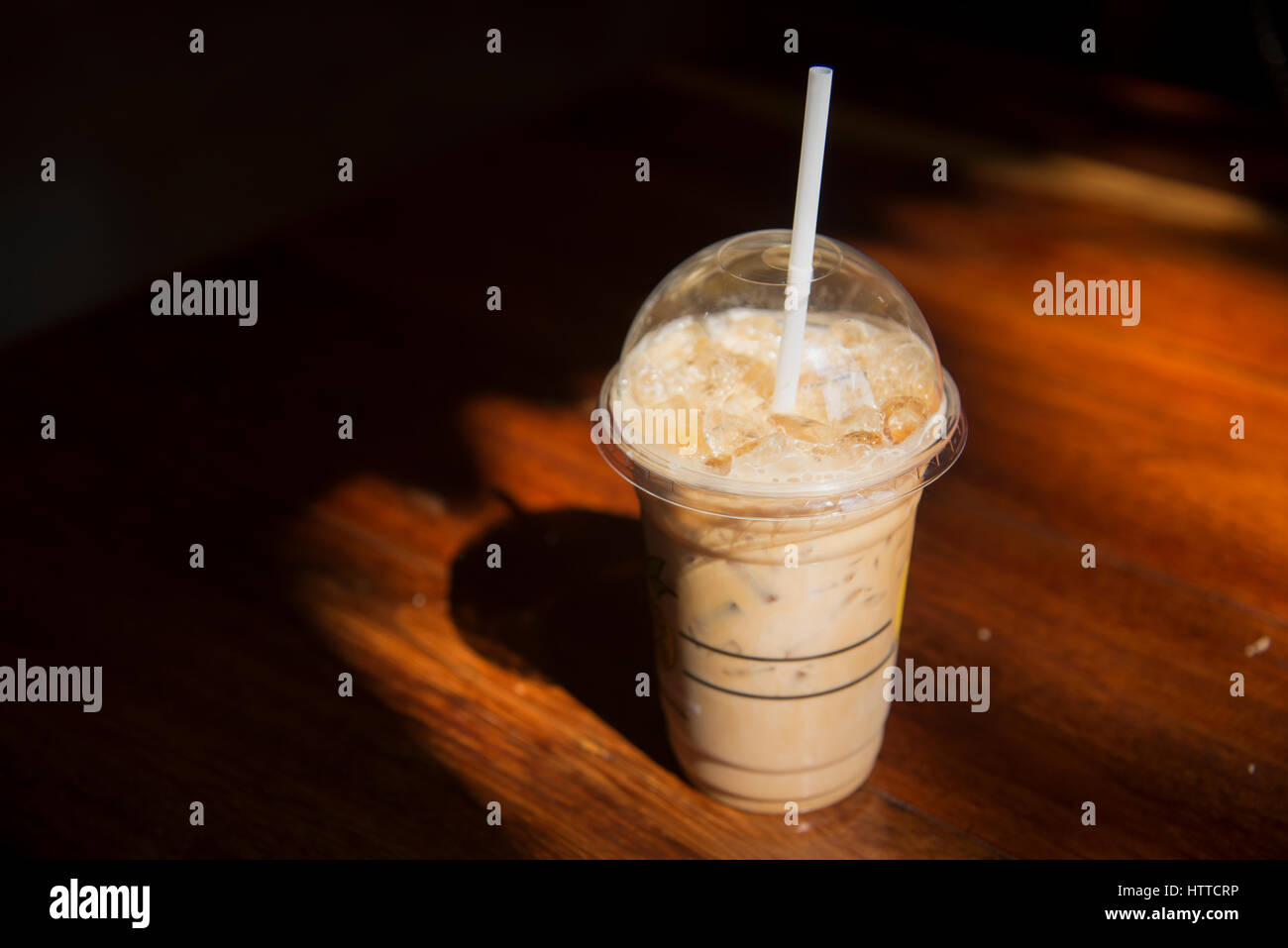 picture Cold Coffee Pics Hd https www alamy com stock photo cold coffee in plastic cup on brown wooden table at cafe 135761242 html