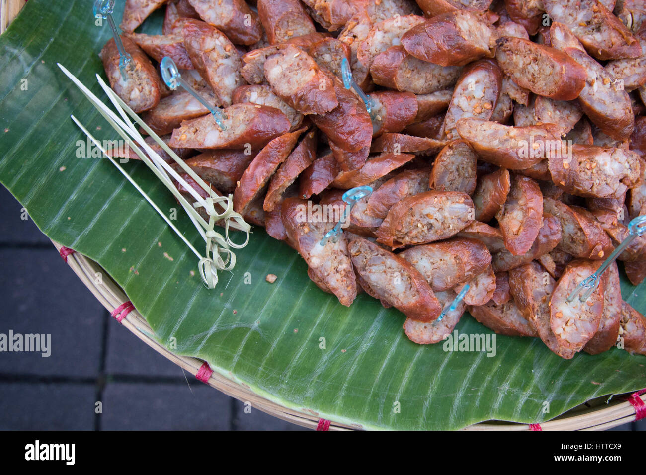 Sai ua or northern Thai sausage or Chiang Mai sausage slice on banana leaf Stock Photo
