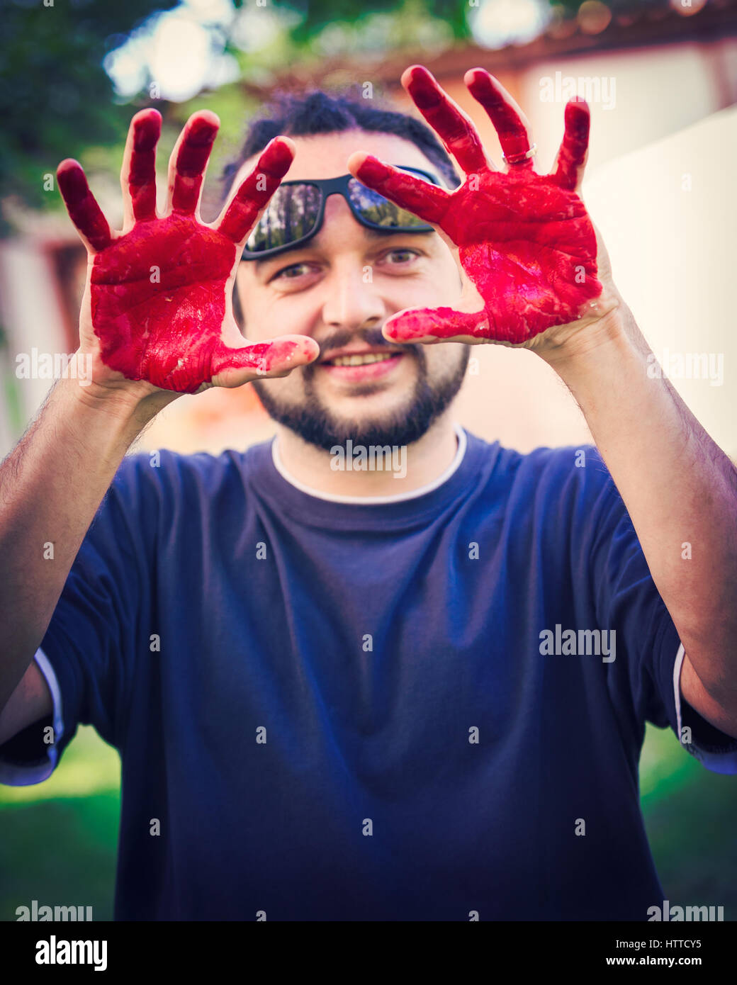 Man with hands painted with red body paint Stock Photo Alamy