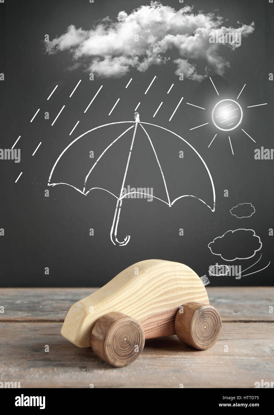 Umbrella protecting a toy car from clouds and rain Stock Photo Alamy
