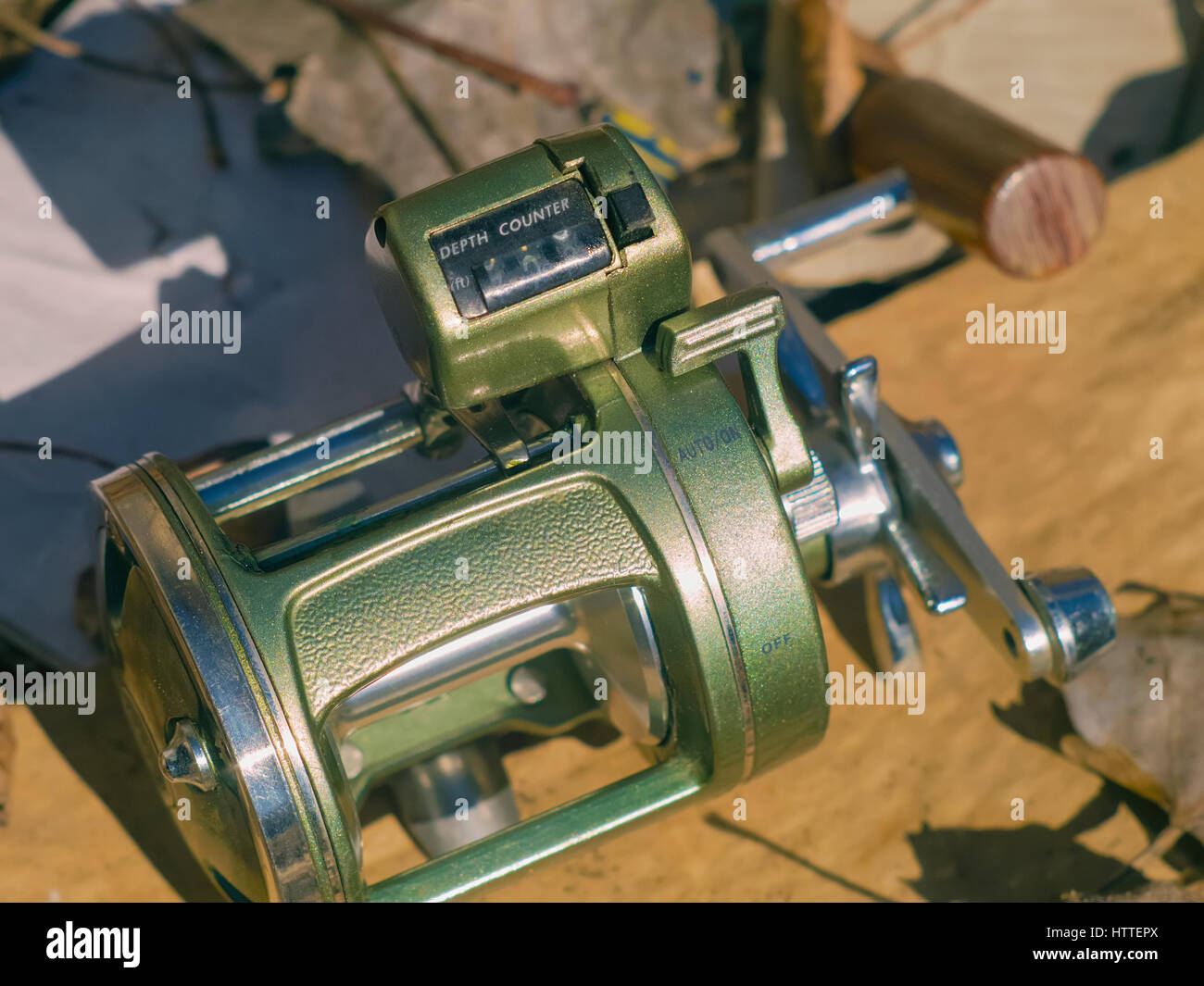 A beautiful reliable fishing reel on the leaves Stock Photo