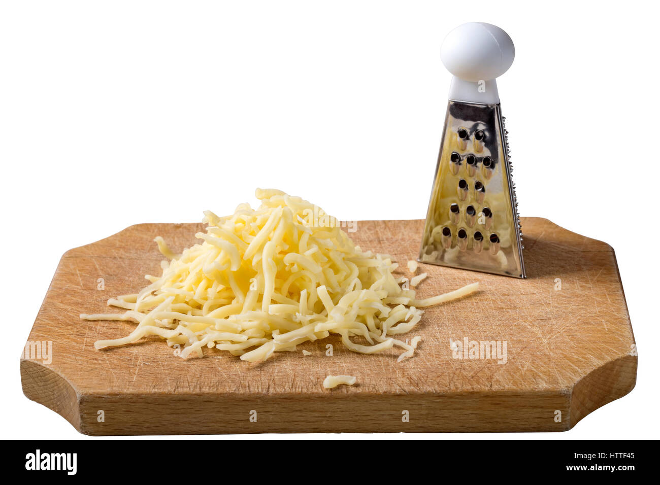 Grated cheese mix on wooden cutting board with one little grater isolated over white background with clipping path Stock Photo