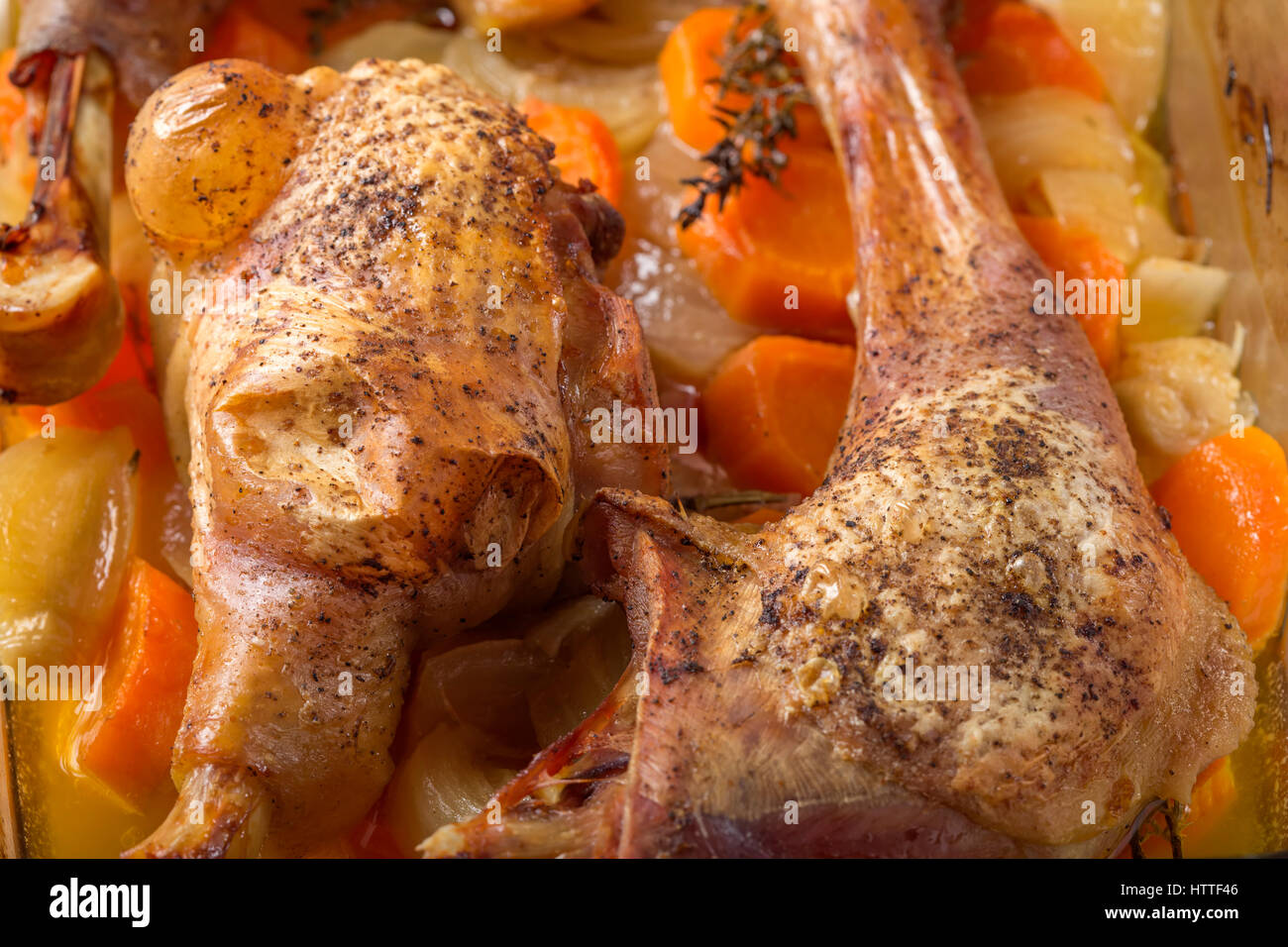 Roast chicken in tray with carrot and onion Stock Photo