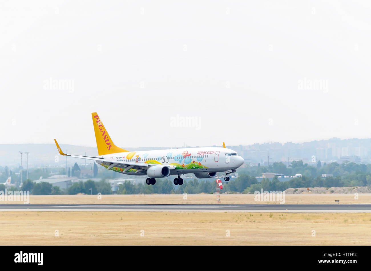 Plane Boeing 737, of Pegasus Airlines airline, is landing on Madrid - Barajas, Adolfo Suarez airport. Turkish low-cost flights. Cloudy day of summer. Stock Photo