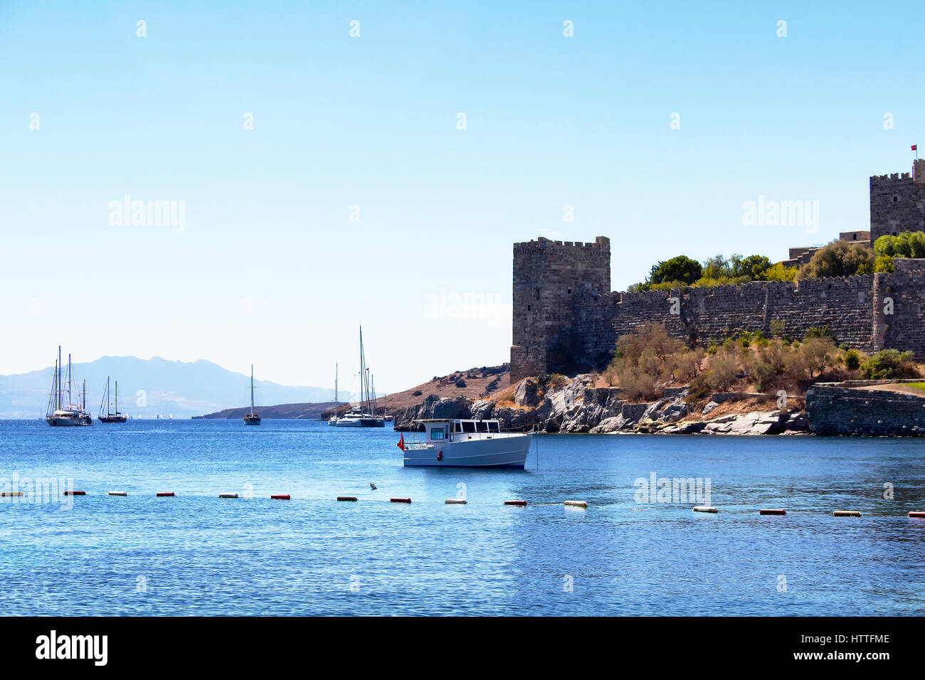 Luxury yachts (sailing boats) parked on turquoise water in front of Bodrum castle. The image shows Aegean and Mediterranean culture of coastel lifesty Stock Photo