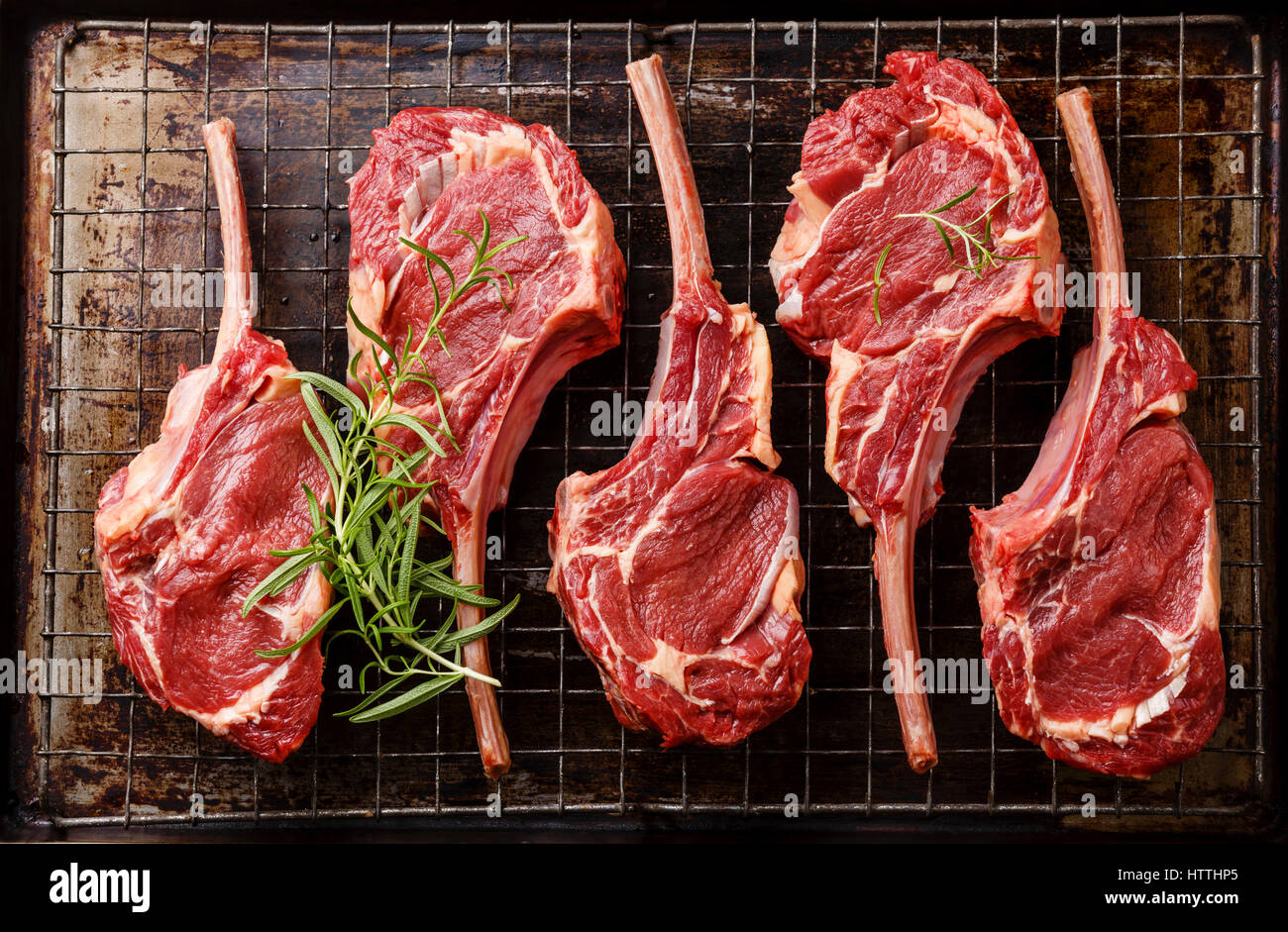 Raw fresh meat Veal ribs on metal grid baking sheet tray Stock Photo