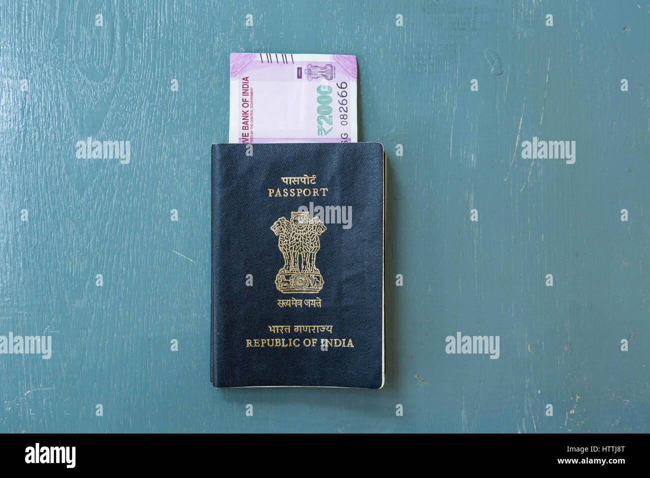 Close-up of Indian passport and American Twenty Dollar Bills on plain background Stock Photo