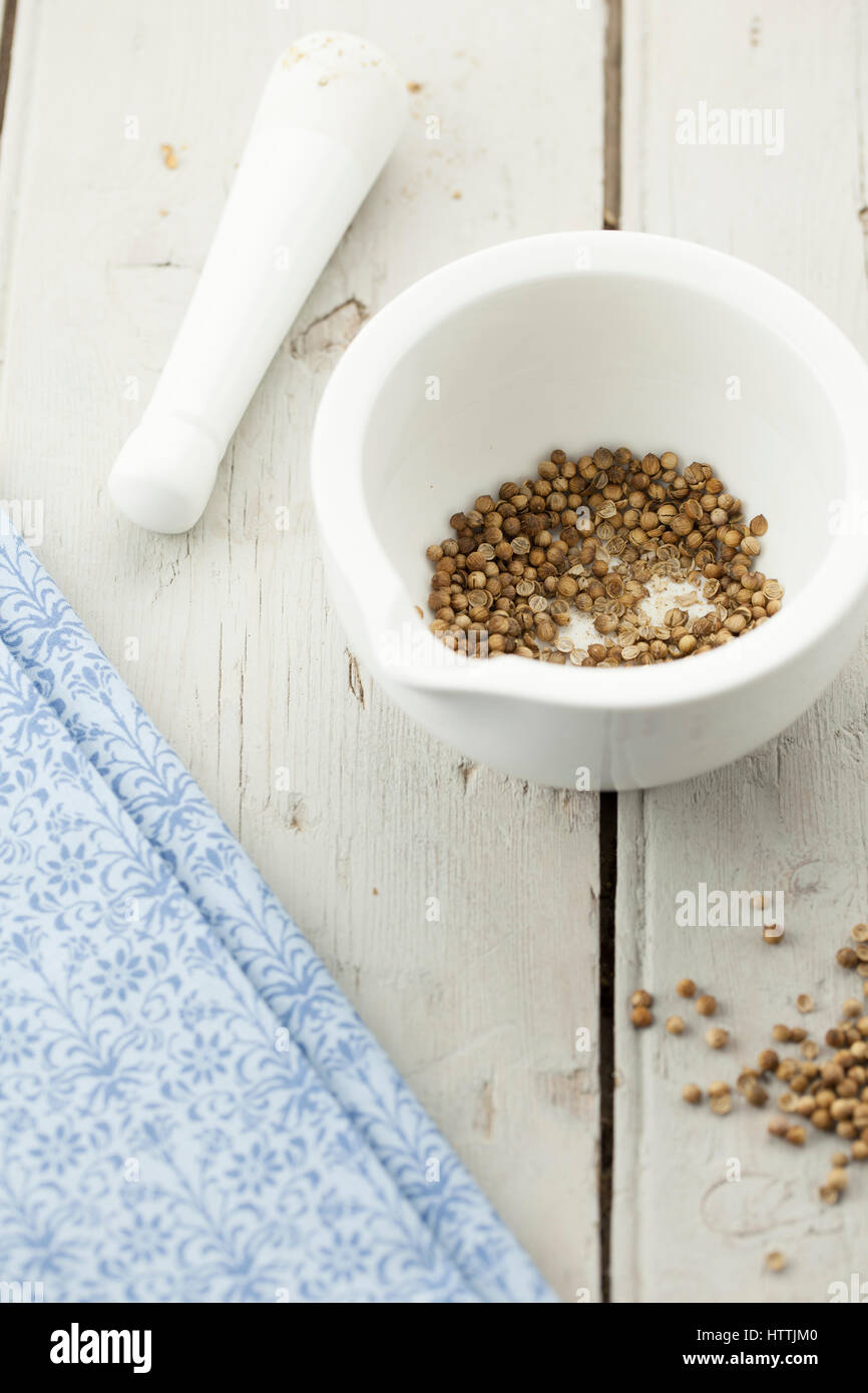Coriander Seeds in Pestle and Mortar Stock Photo