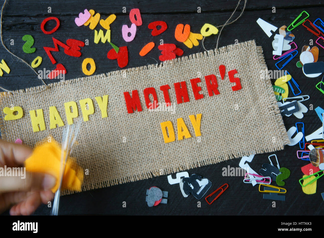 Happy mothers day with i love mom message,  idea from colorful letter on wooden background, woman hand cutting character to make gift for mother on ha Stock Photo