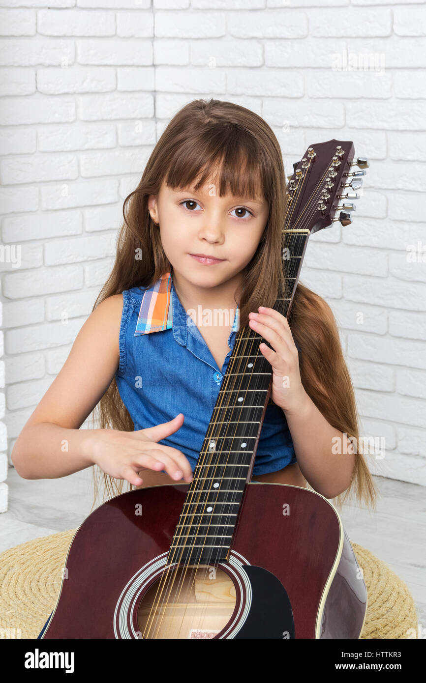 little girl playing the guitar Stock Photo
