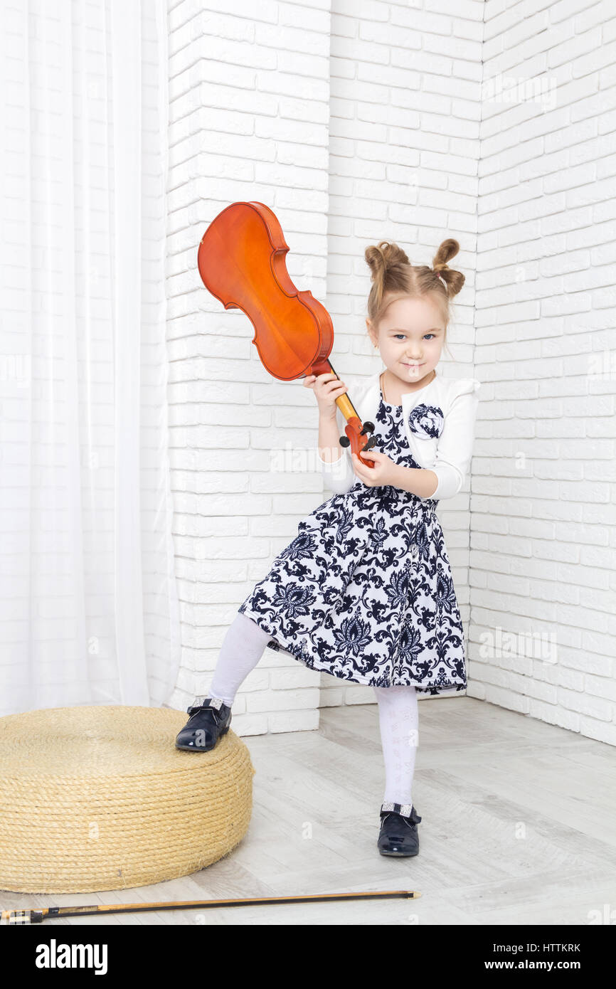 little girl swings violin Stock Photo