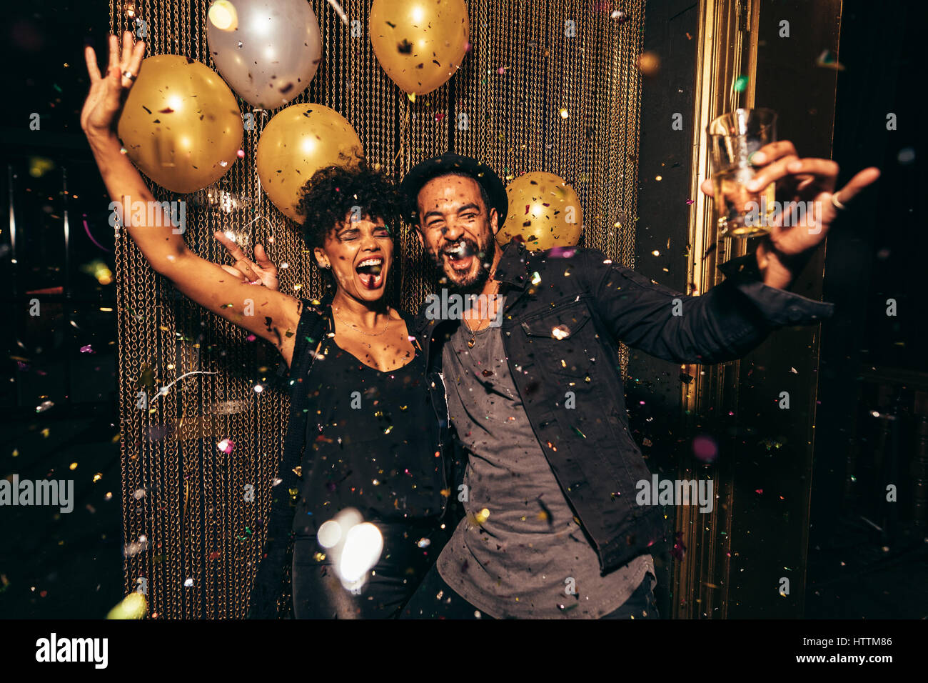 Shot of energetic couple dancing in the night club. Young man and woman having fun at pub party. Stock Photo