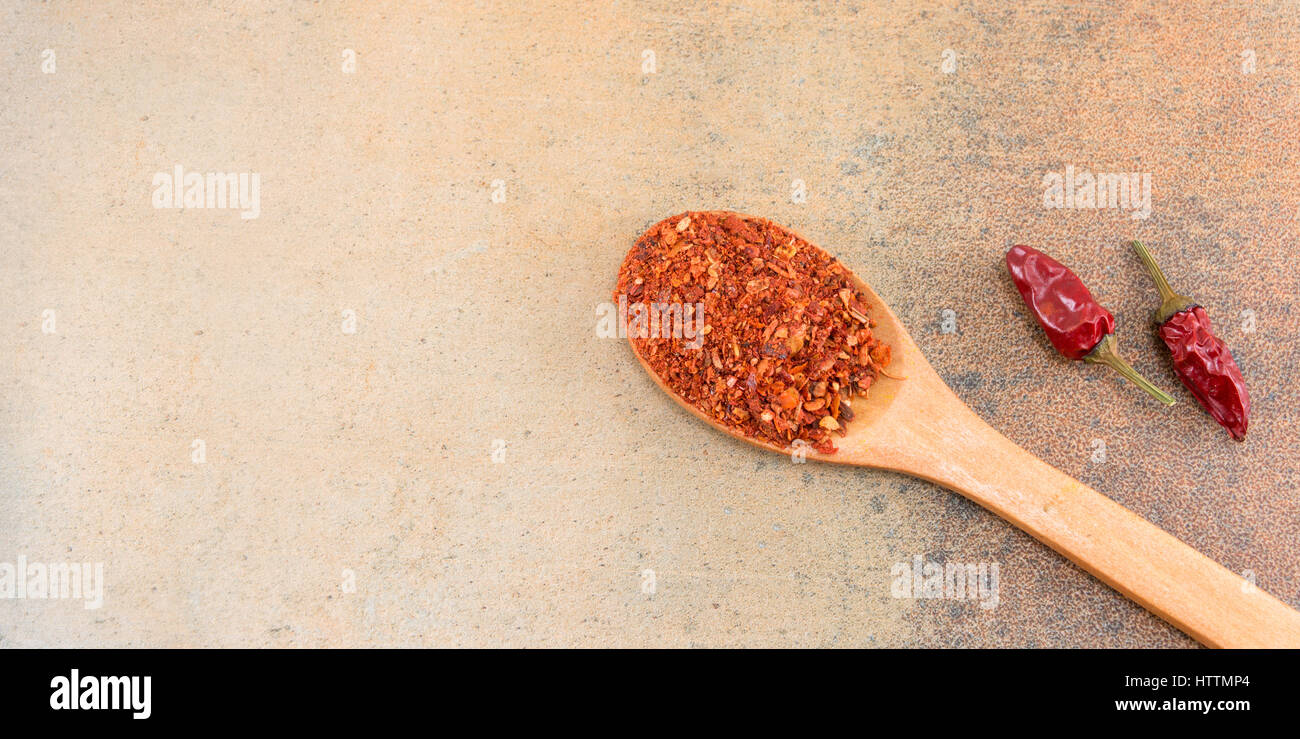 Grounded and dry red pepper on stone background Stock Photo