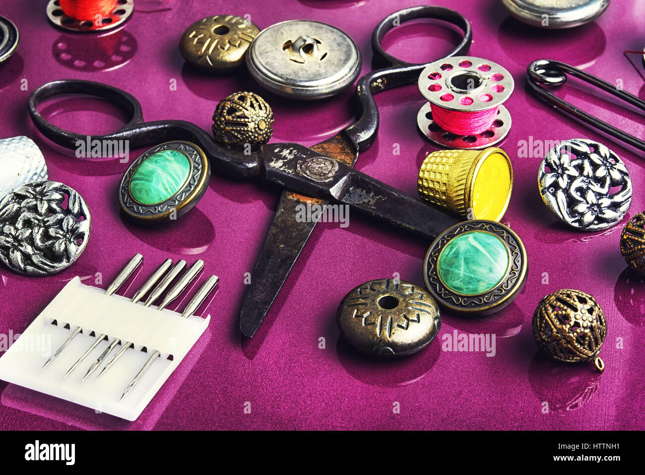 Set of beautiful buttons,sewing needle and bobbin Stock Photo - Alamy