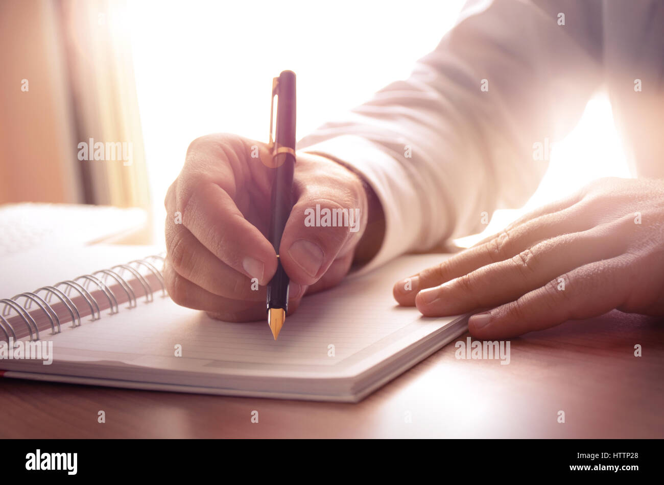 Businessman writing on a notebook. Image can be used for several purposes like: background, website banner, promotional materials, poster, presentatio Stock Photo