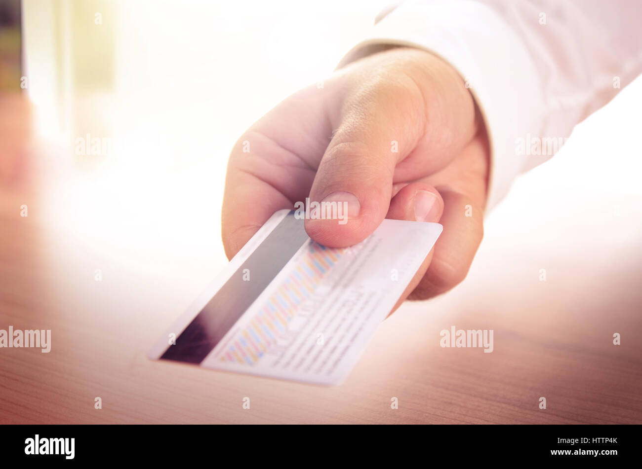 Man’s hand holding a credit card. Concept for business, finance, banking, shopping. Stock Photo